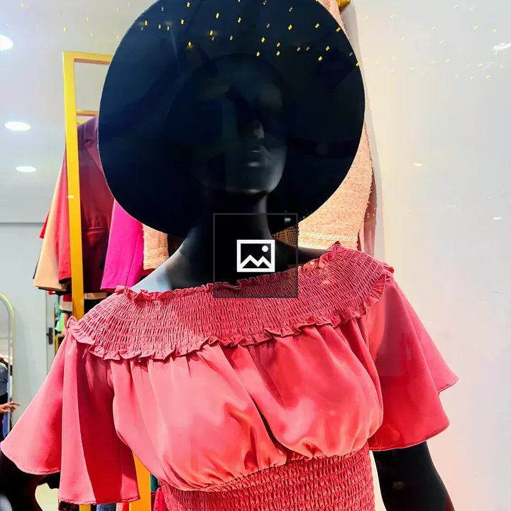 Black mannequin with pink top and hat