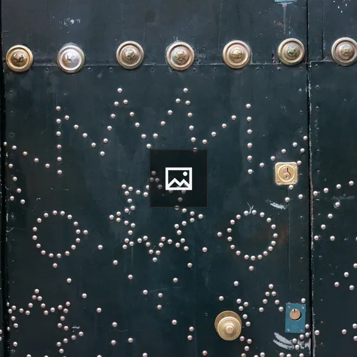Green church door with brass ornaments