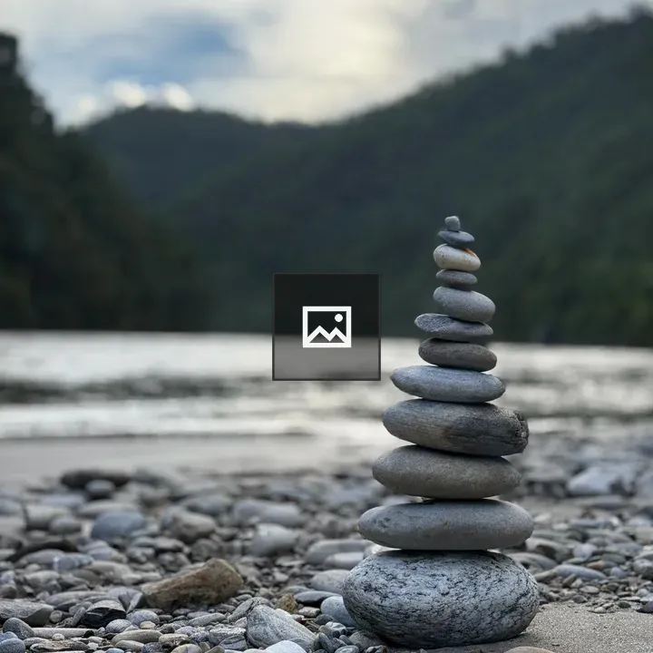 Stone tower on pebbled shore