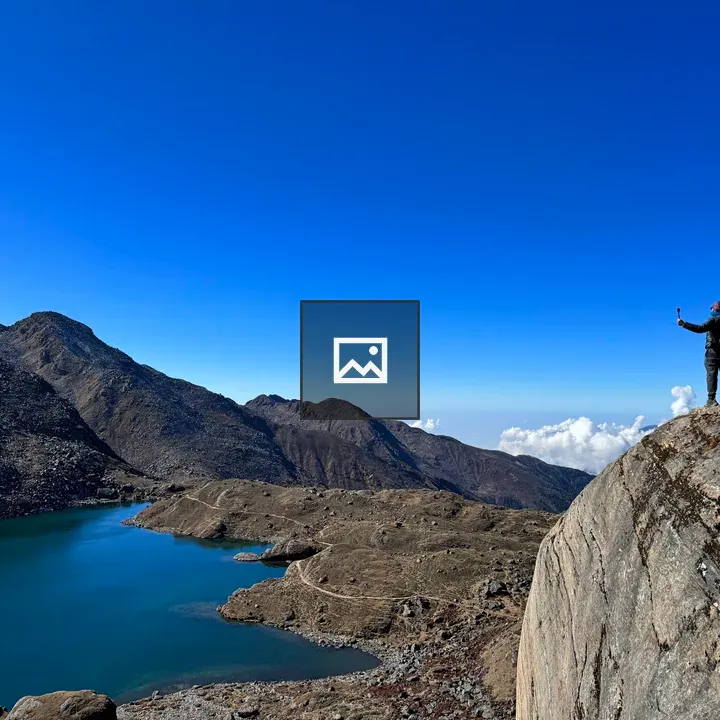 Hiker overlooking alpine lake