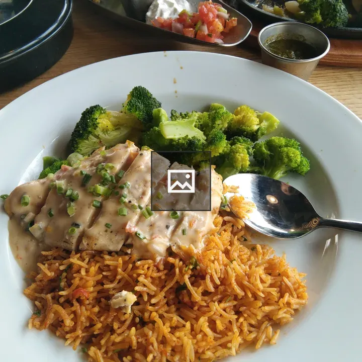 Plate with sliced chicken, rice, and broccoli