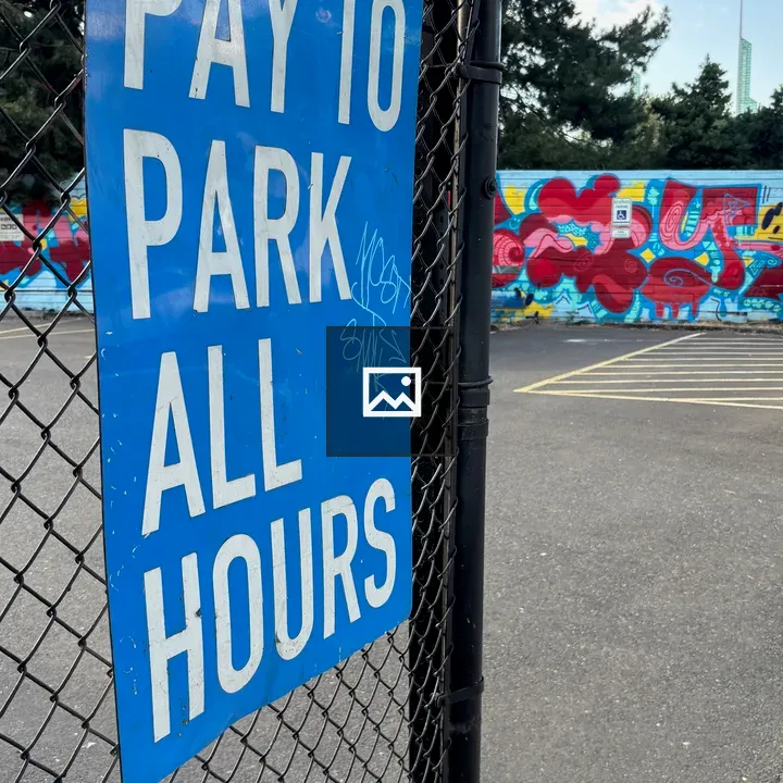 Pay to Park Sign on Fence