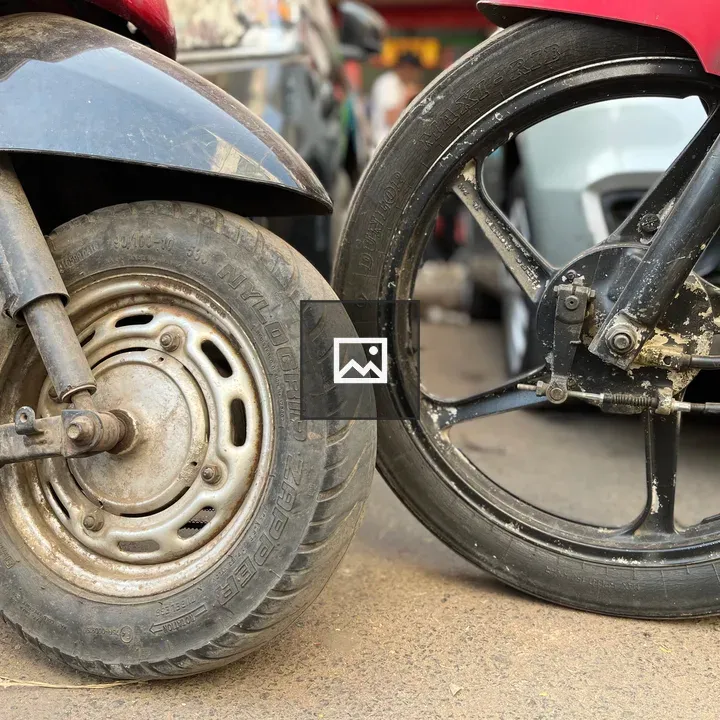 Close-up of scooty and bike wheels