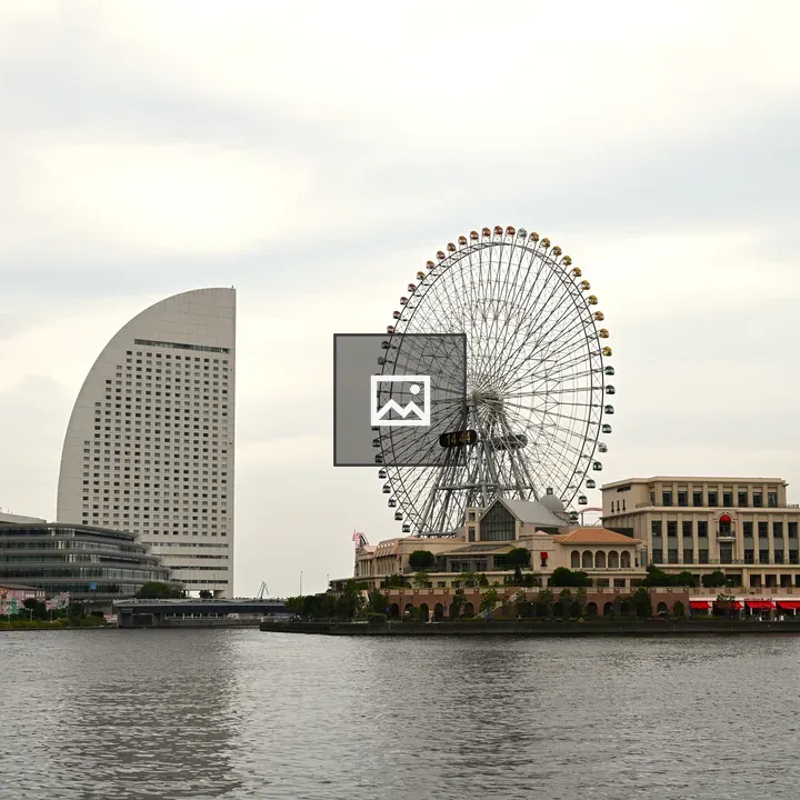Ferris wheel beside modern building
