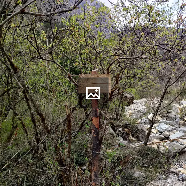 Wooden sign in rocky landscape