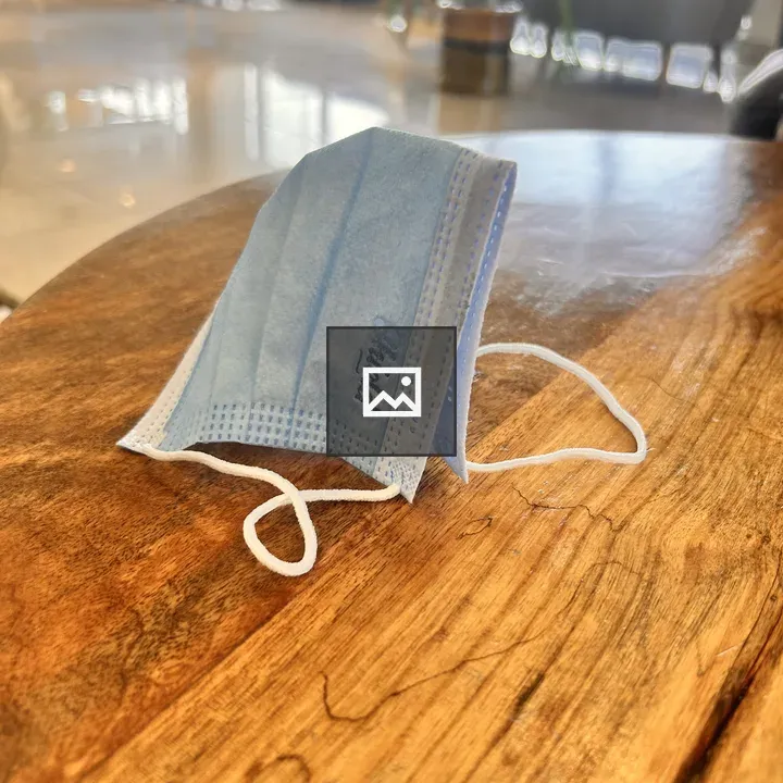 Blue face mask on wooden table