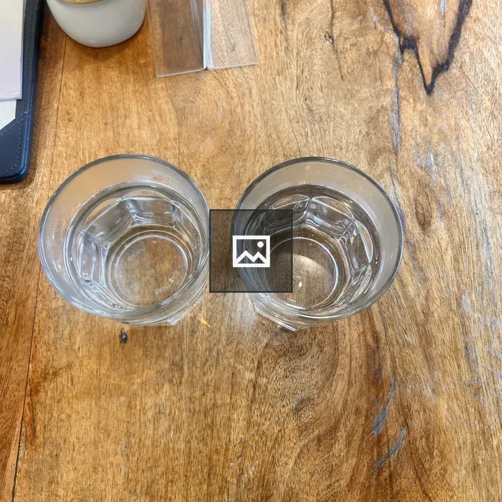 Two glasses of water on a wooden table