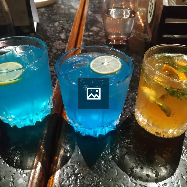 Three colorful drinks on a table