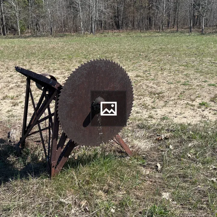 Rusty old sawmill in field