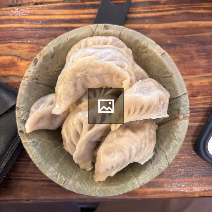 Bowl of steamed dumplings on wood