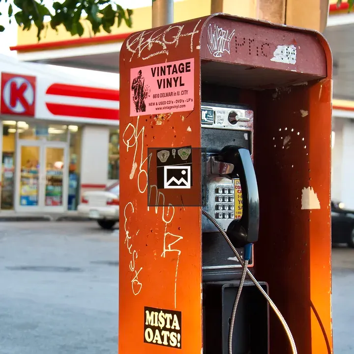 Phone booth with stickers on The Loop