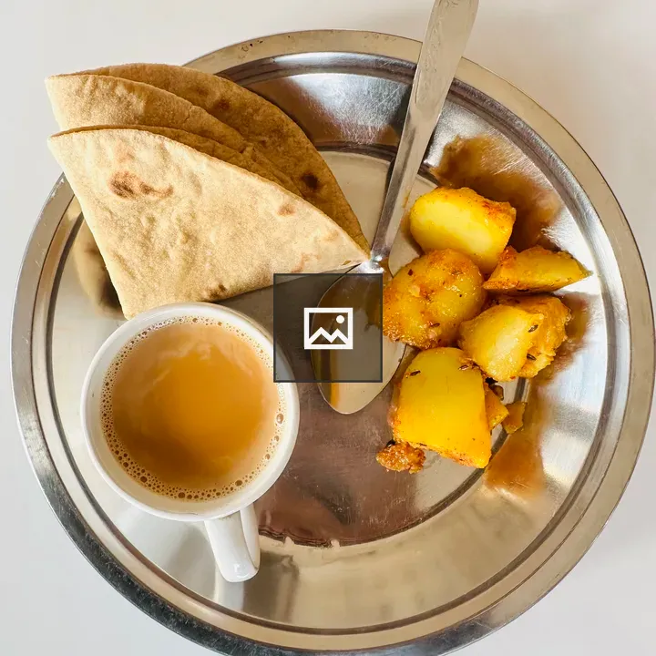 Plate of fried potatoes with tea