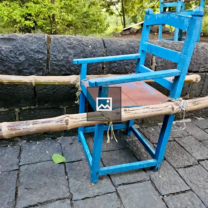 Blue wooden chair on path