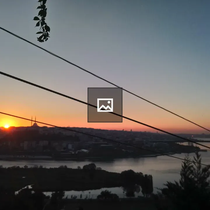 Sunrise over cityscape silhouettes