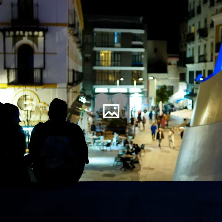 Back view of couple on stairs at night