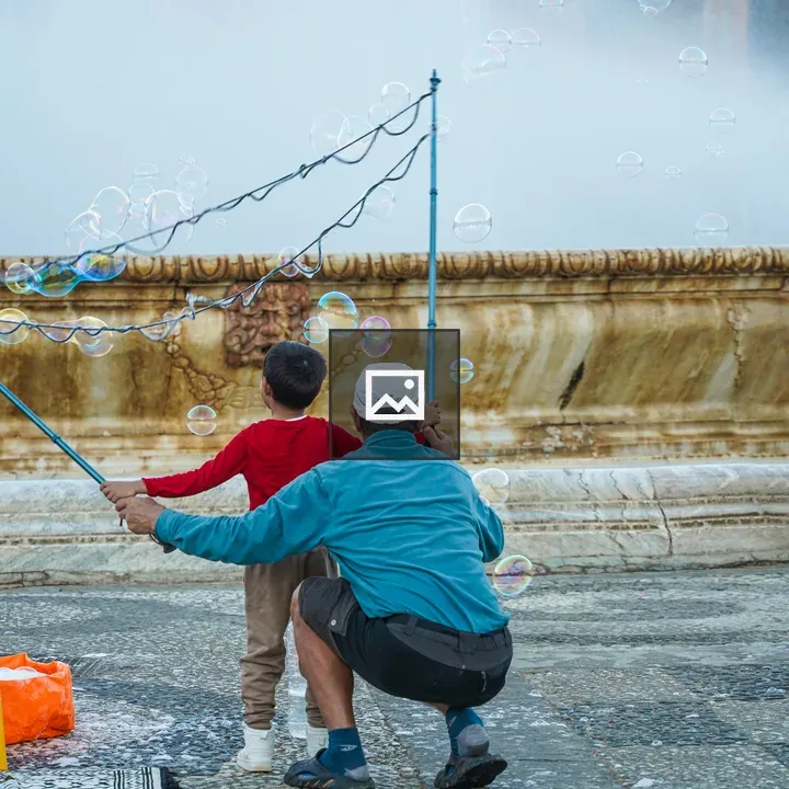 Child with Bubble Wand and Fountain