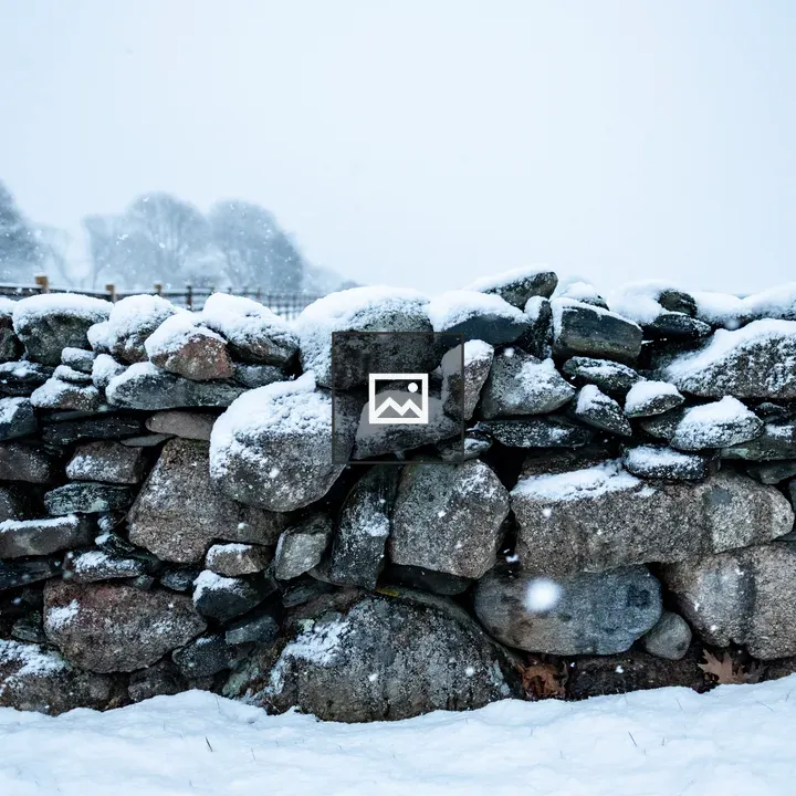 Snow on old stone wall