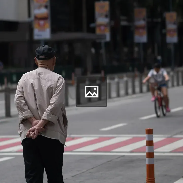 Old Man and Woman on Bike Distance