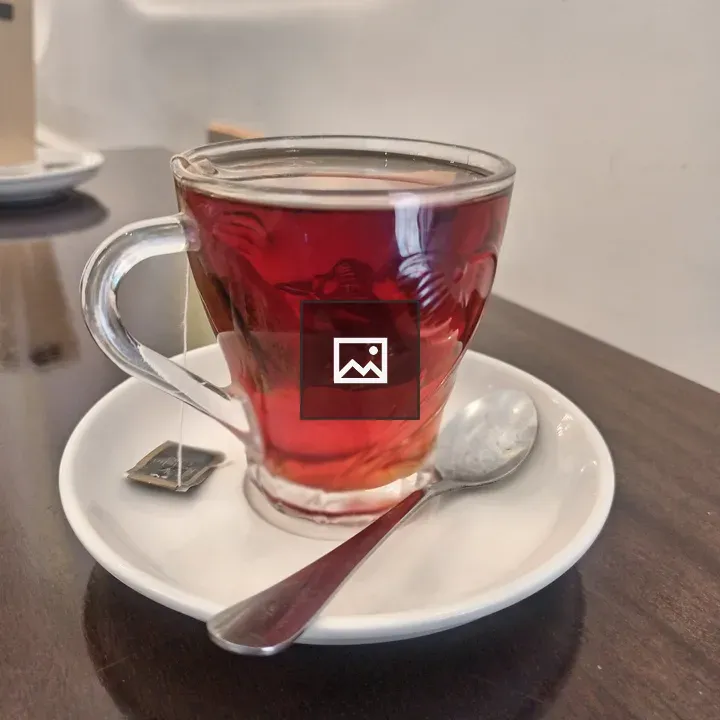 Tea in a glass cup on saucer
