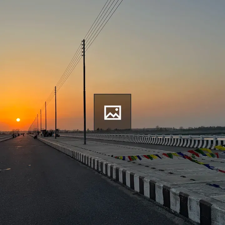 Sunset over road with barriers