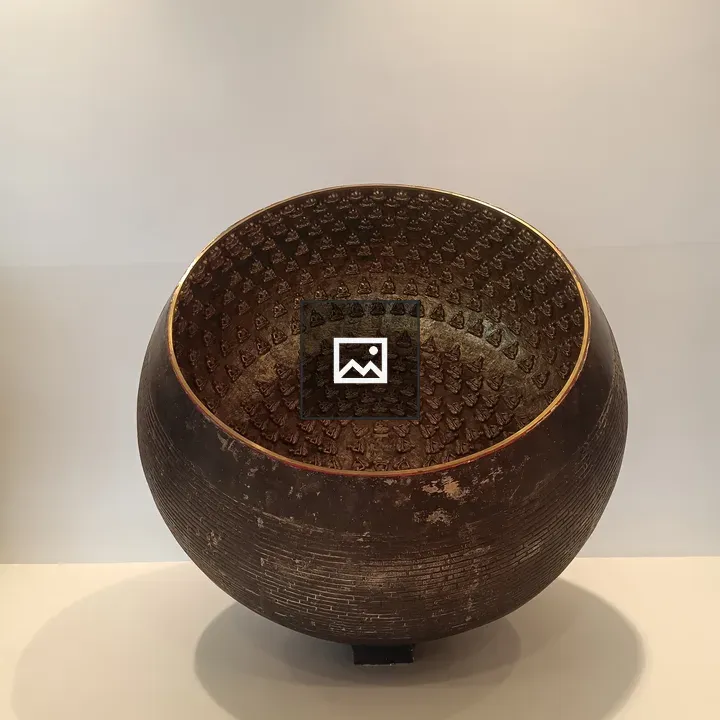 Metal bowl with Buddha figures