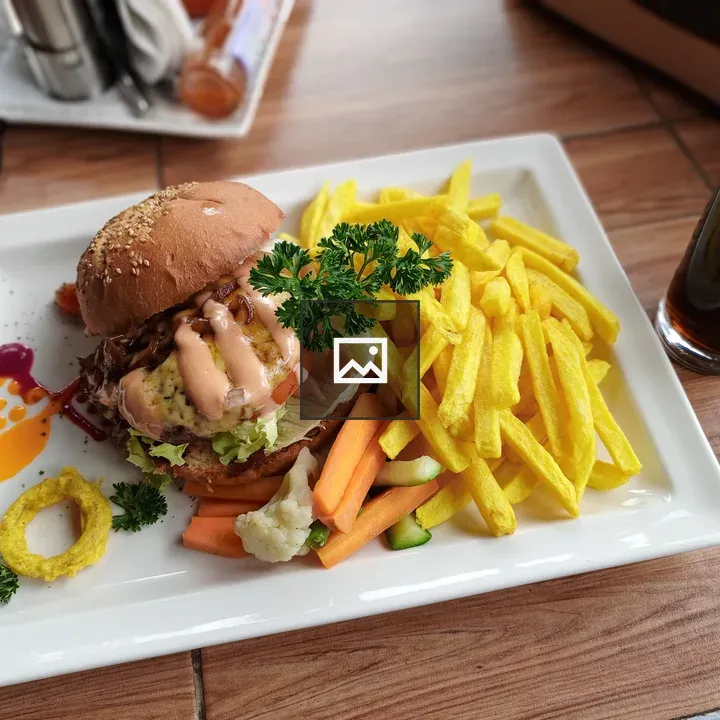 Chicken burger on plate with sides
