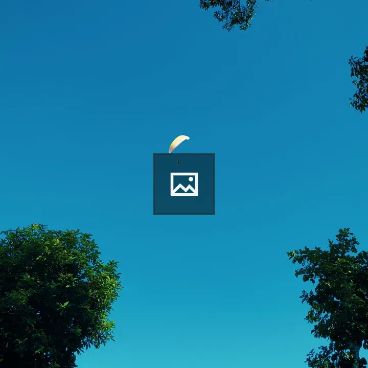 Paraglider under blue sky