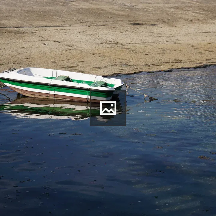 Boat Tethered in Clear Water