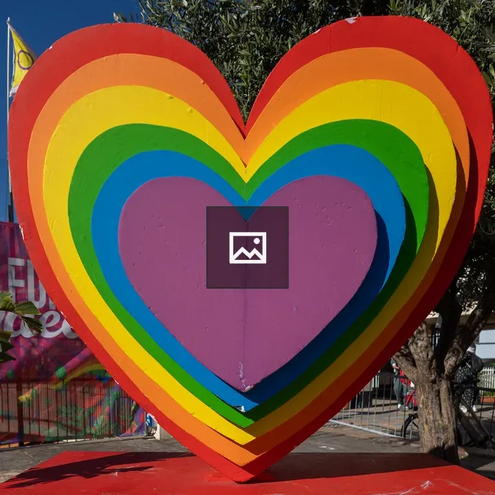 Rainbow heart with tree and city