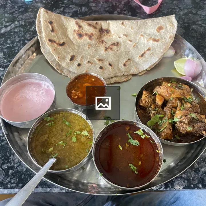 Stainless steel plate with Indian dishes