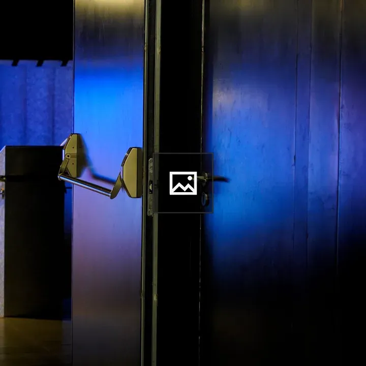 Dim hallway with blue lighting and door