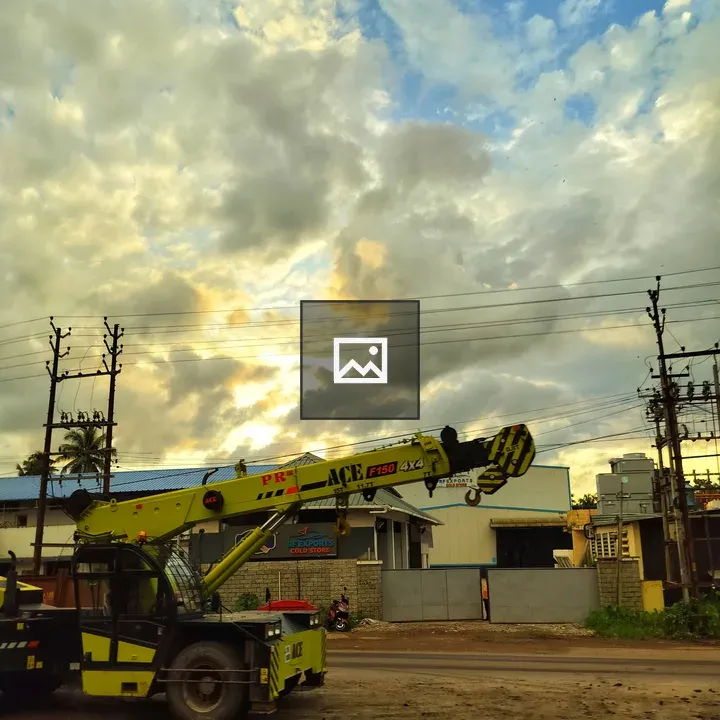 Yellow mobile crane by road