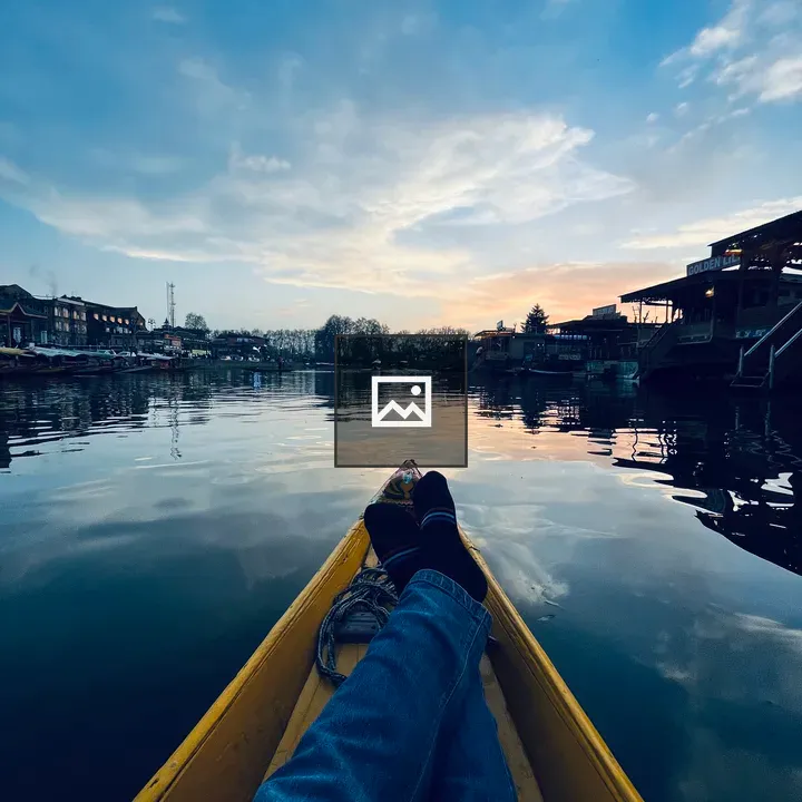 Person in blue jeans on yellow boat