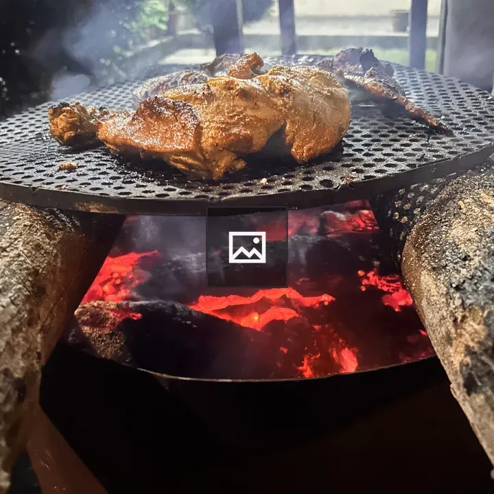 Chicken grilling on metal grate