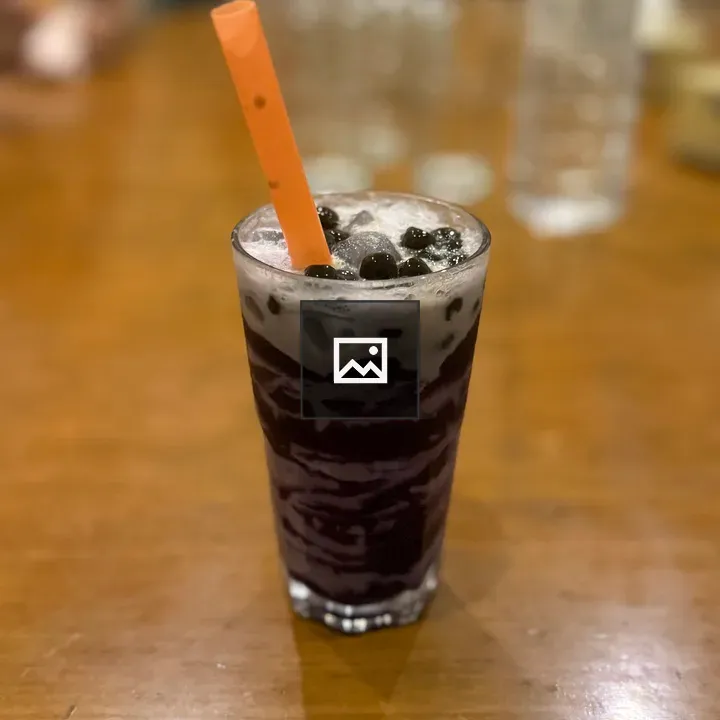 Dark bubble tea on wooden table