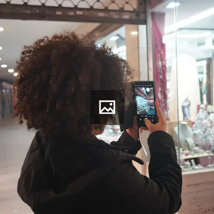 Person photographing store display