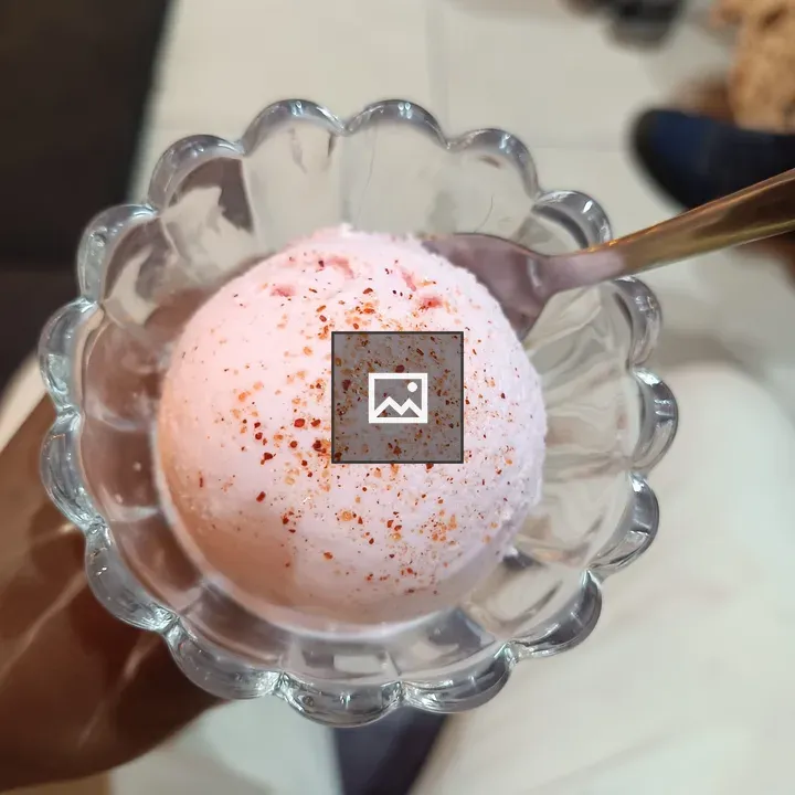 Pink ice cream in glass bowl