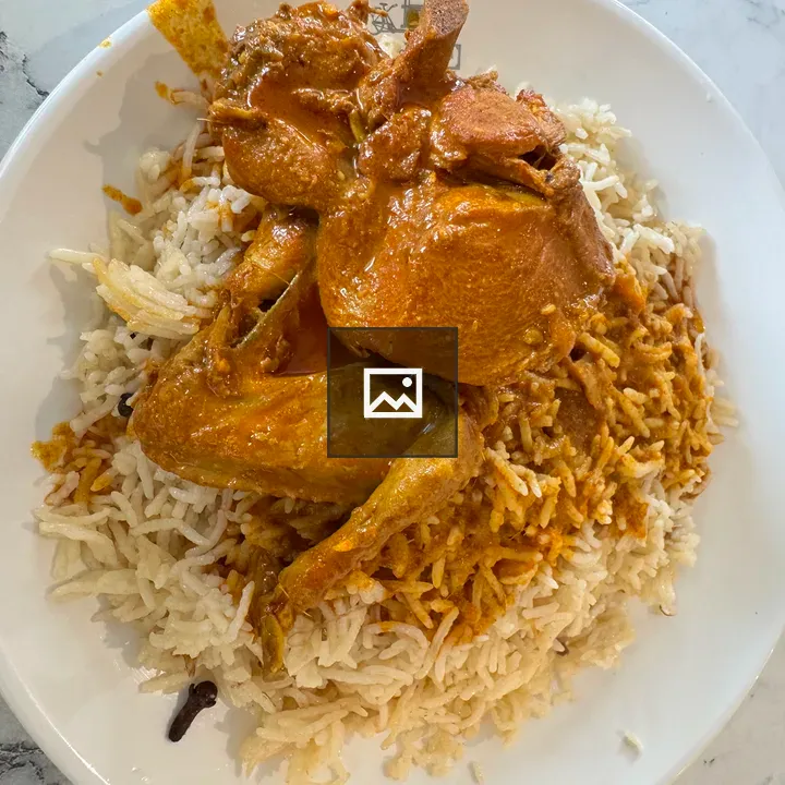 Rice with chicken in orange gravy