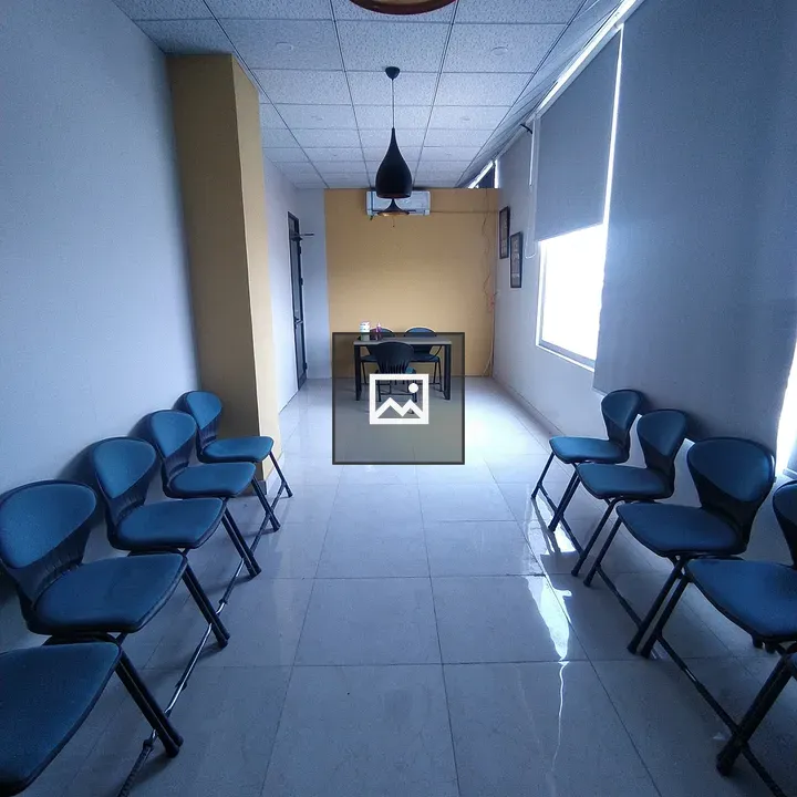 Narrow hallway with blue chairs