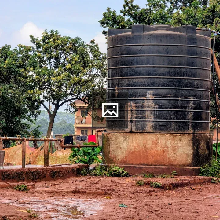 Black water tank on muddy ground