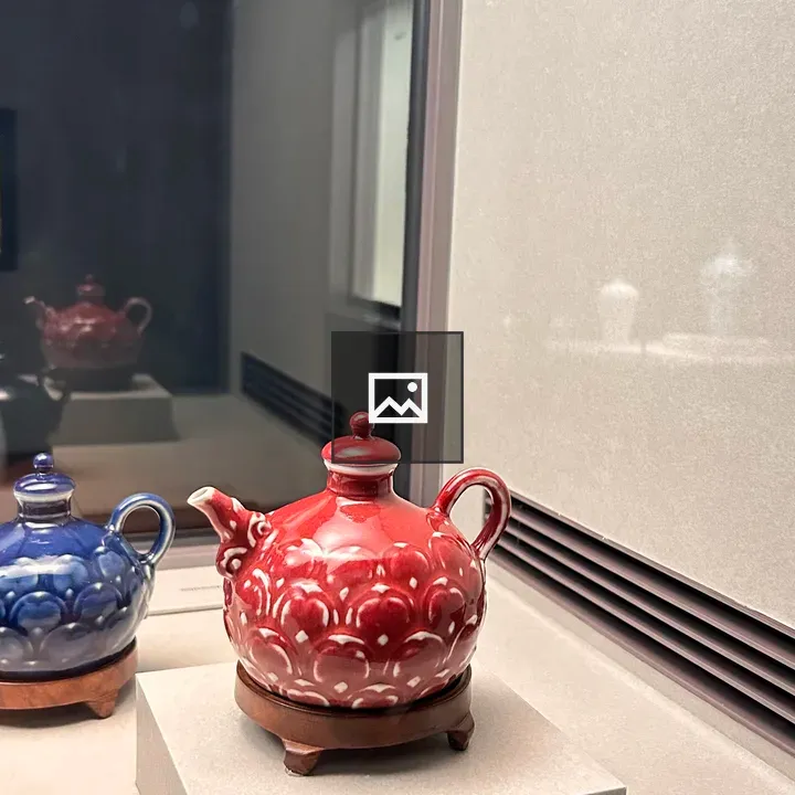 Decorative red teapot on pedestal