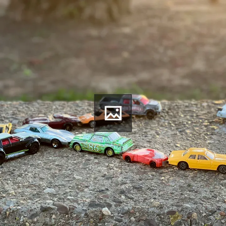 Toy cars on gravel