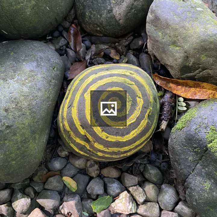 Round stone with yellow spiral