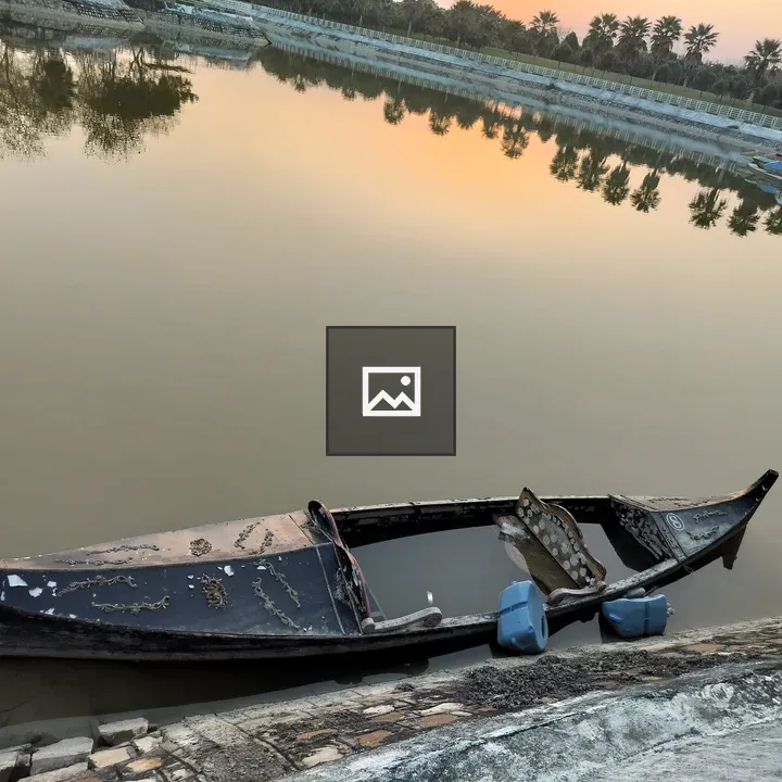 Dilapidated wooden boat at sunset