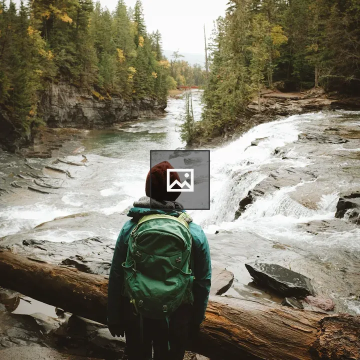 Person in Front of Log by River