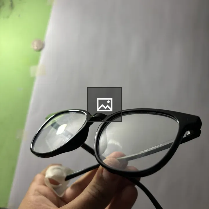 Eyeglasses Held by Person
