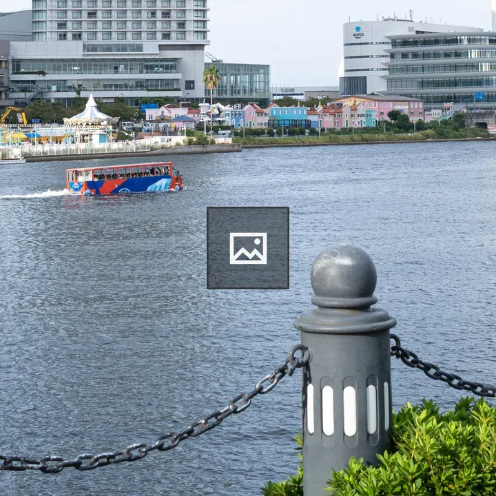 Colorful boat on river with city backdrop