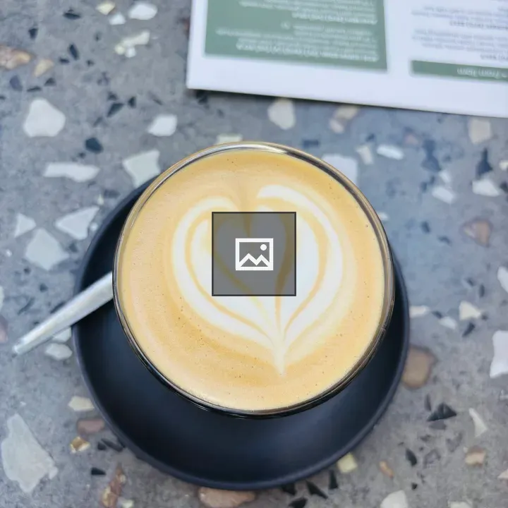 Latte in Black Cup with Heart Foam