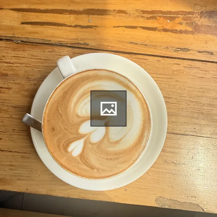 Cup of latte on saucer
