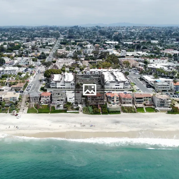 Aerial Beachfront with Urban Backdrop